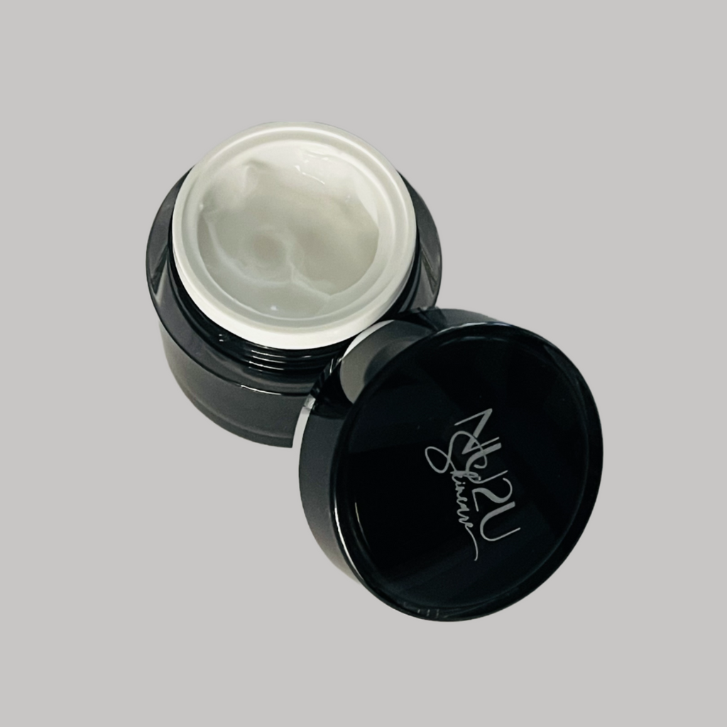 Active Eye Cream jar opened with cap laying to the front of the container.